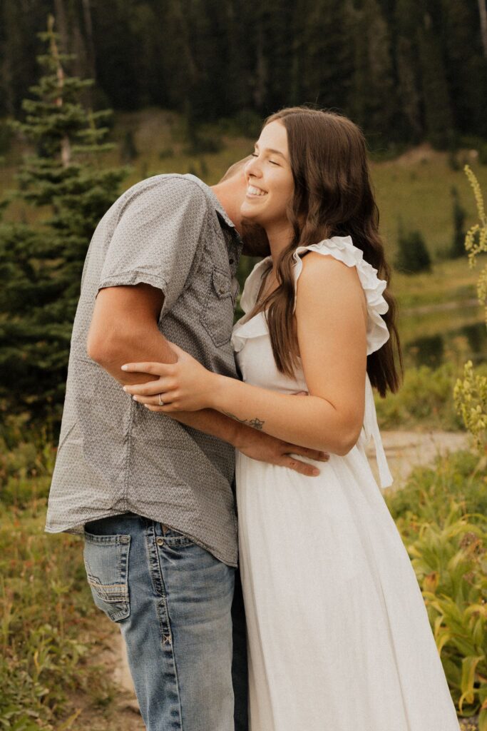 fiance kissing his fiance on the cheek