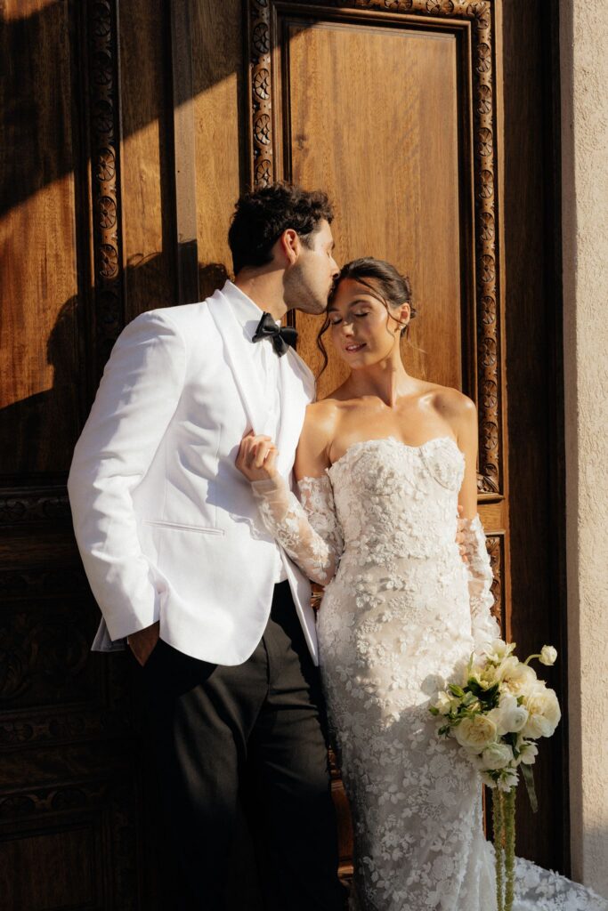groom kissing the bride on the forehead