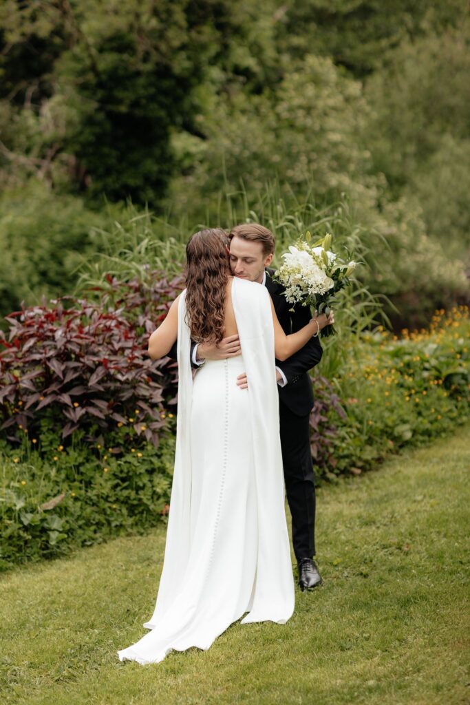 cute picture of the bride and groom hugging after their first loook