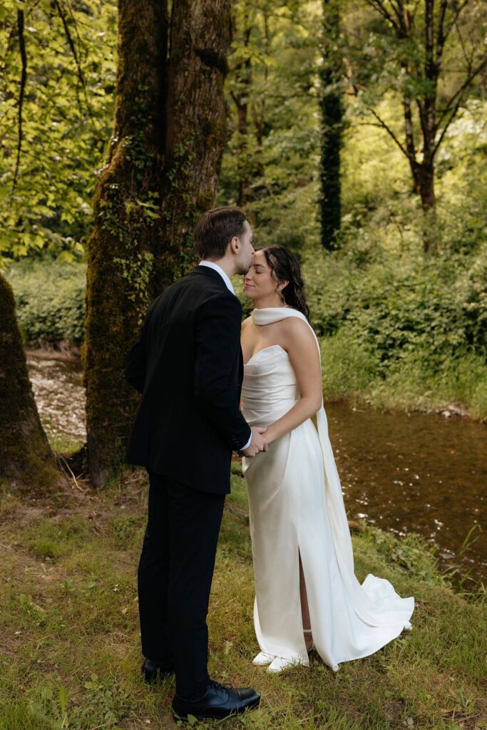 groom kissing the bride on the forehead
