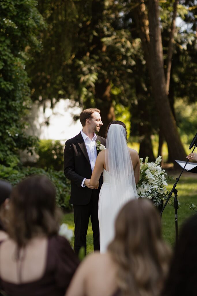 Bride and groom holding hands during their wedding ceremony