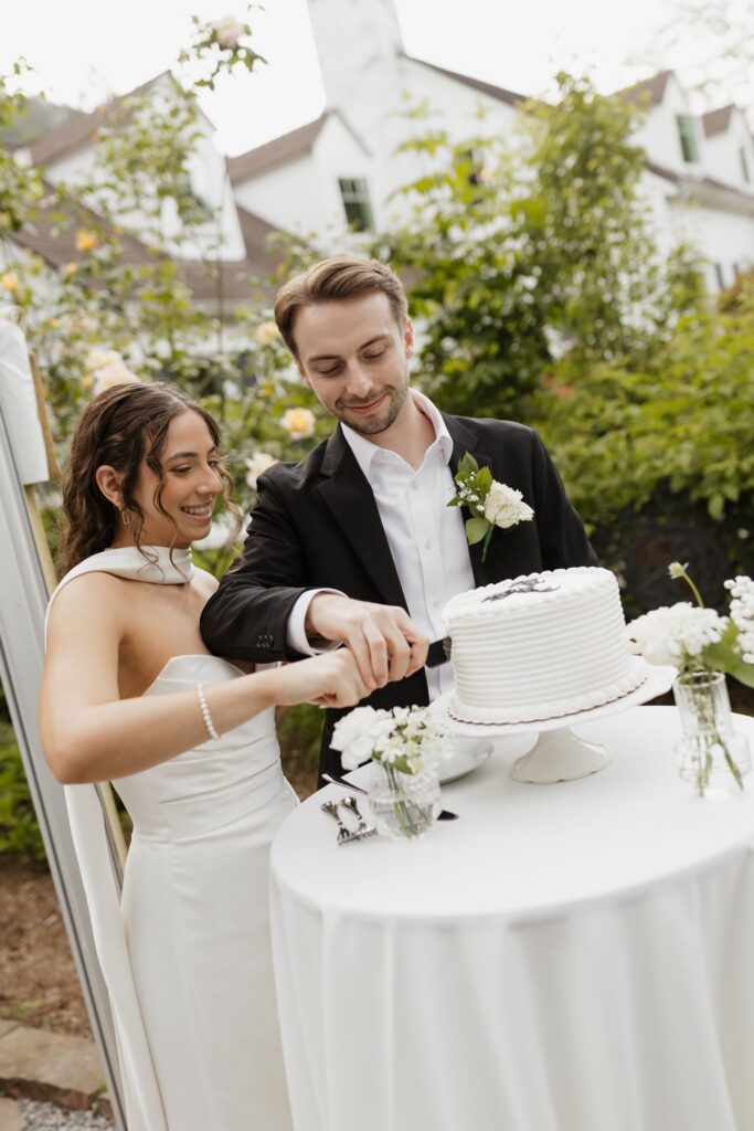Newlyweds cutting their wedding cake