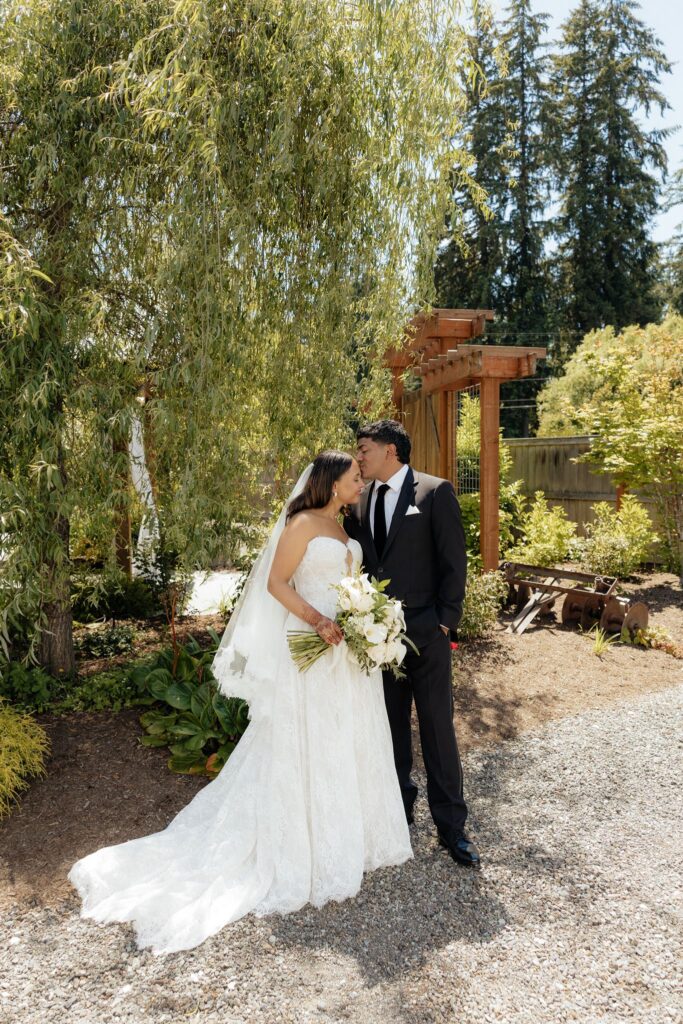 groom kissing the bride on the cheek