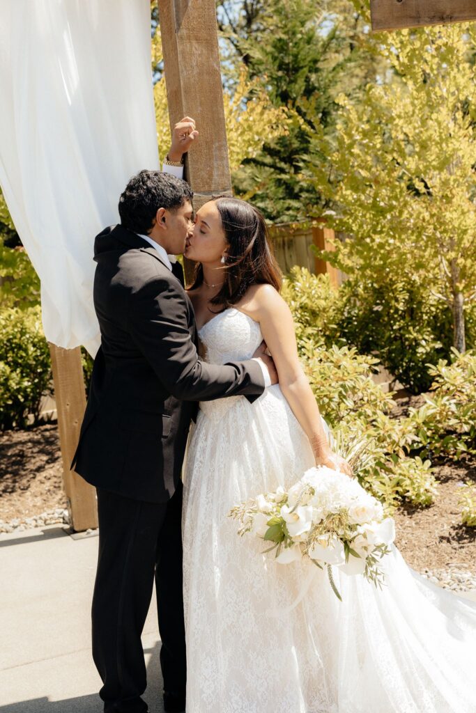 romantic portrait of the bride and groom kissing