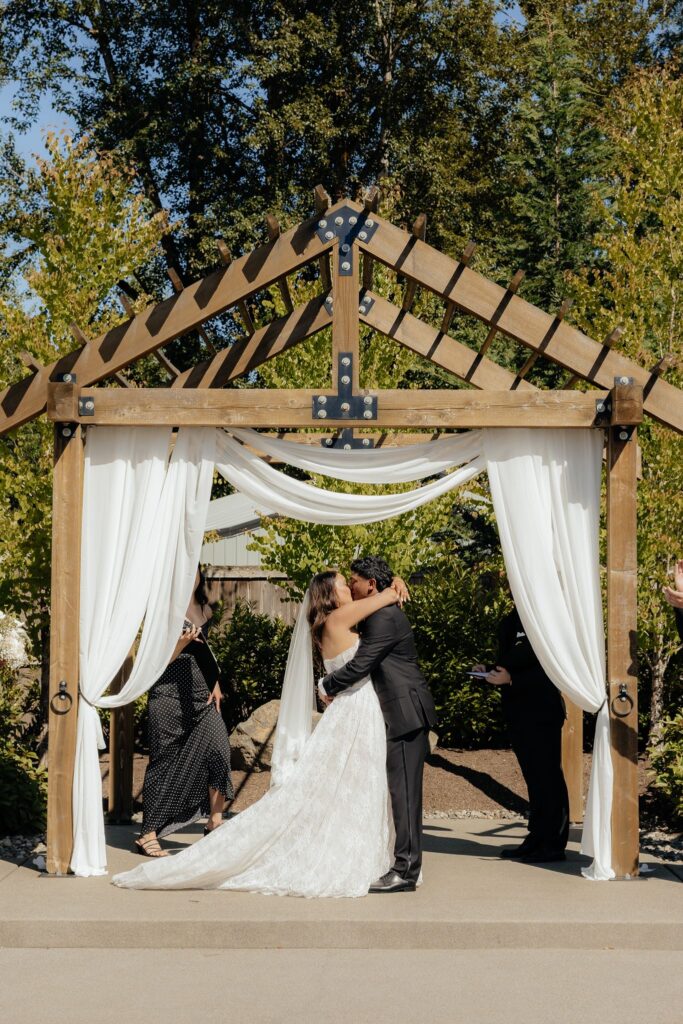 newlyweds kissing after their ceremony