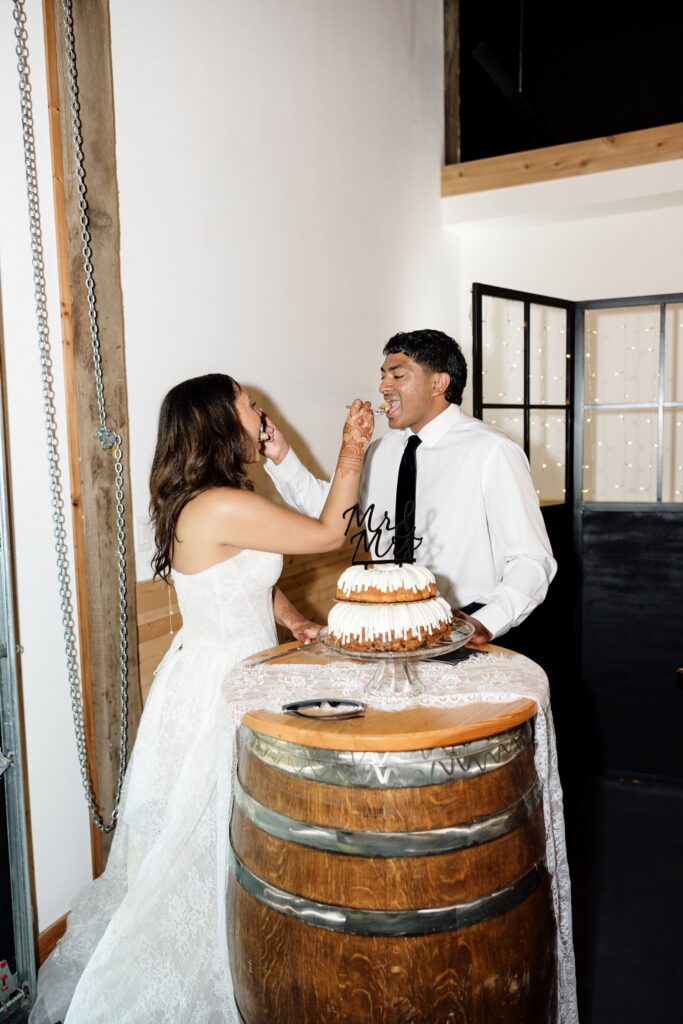 newlyweds trying their wedding cake