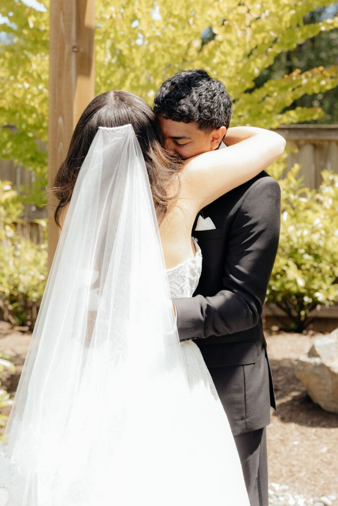 cute picture of the bride and groom hugging after their first look