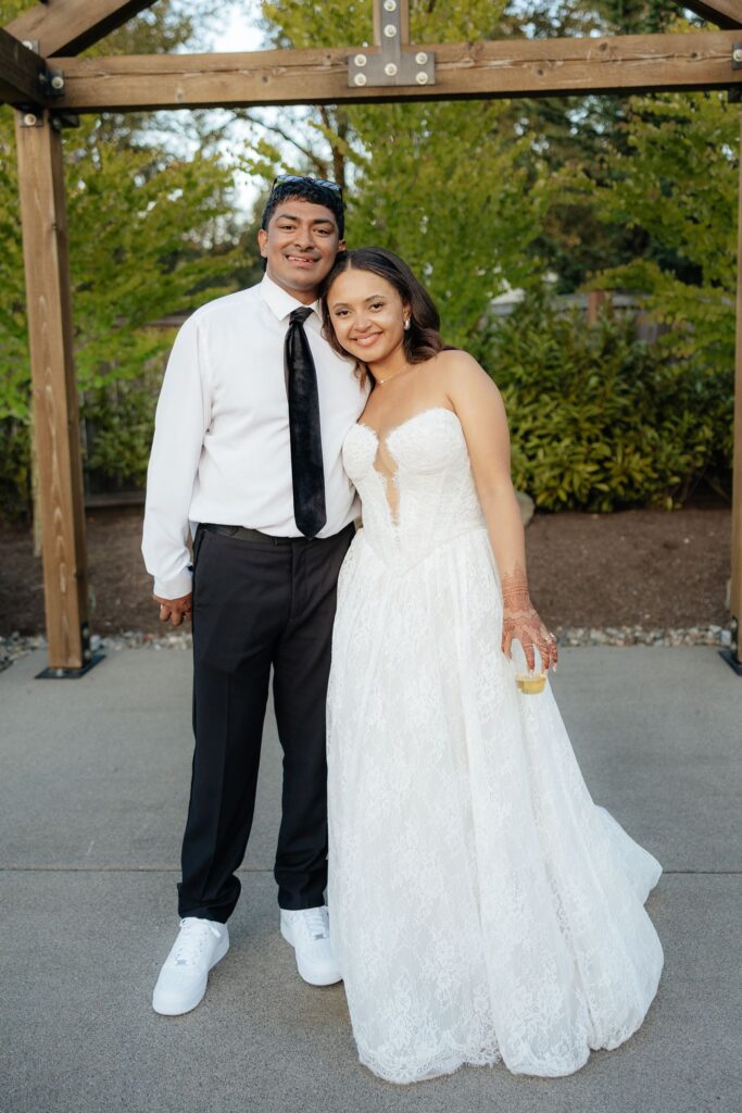 newlyweds smiling at the camera during their session