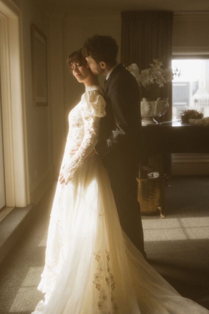 groom kissing the bride on the cheek