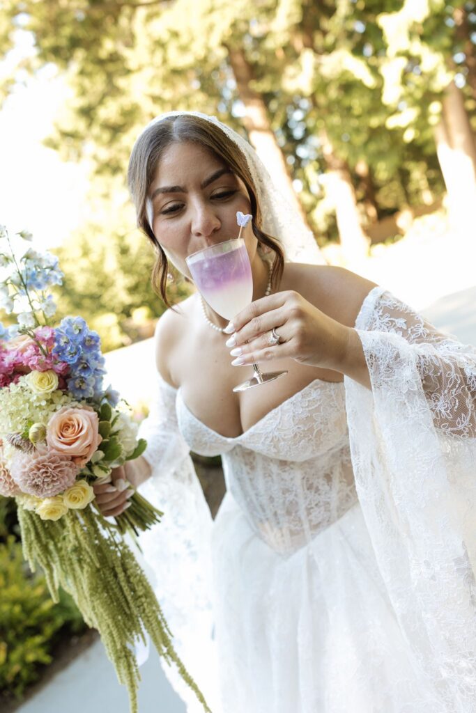 Bride celebrating her wedding day with a drink