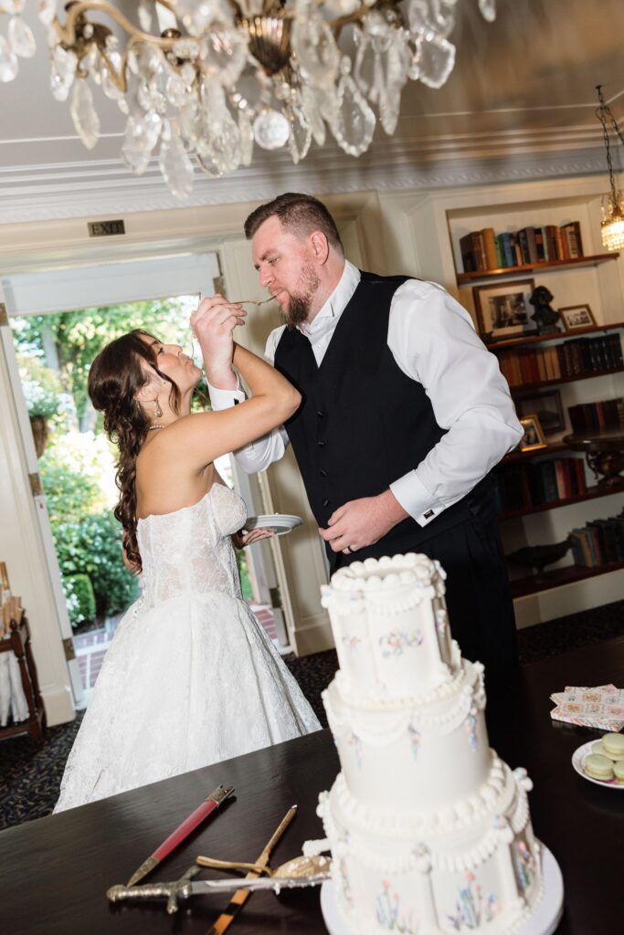 newlyweds trying their wedding cake