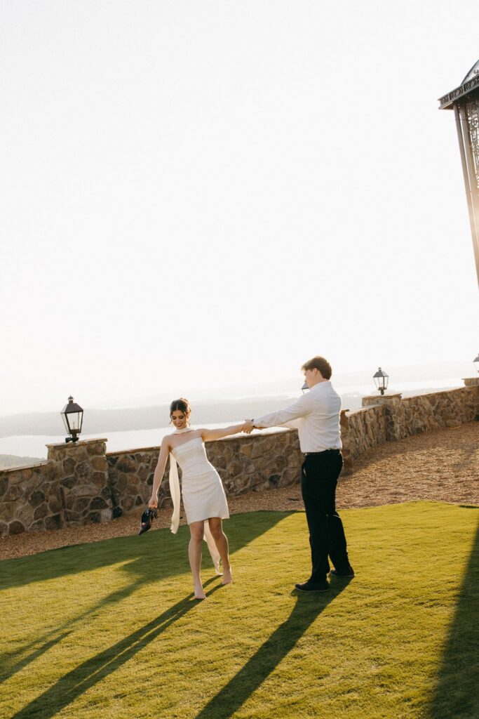 bride and groom dancing during olden hour
