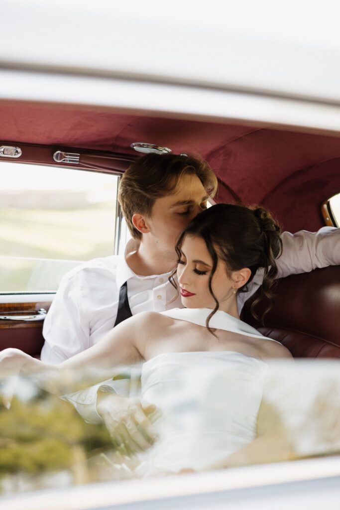 groom kissing the bride on the forehead