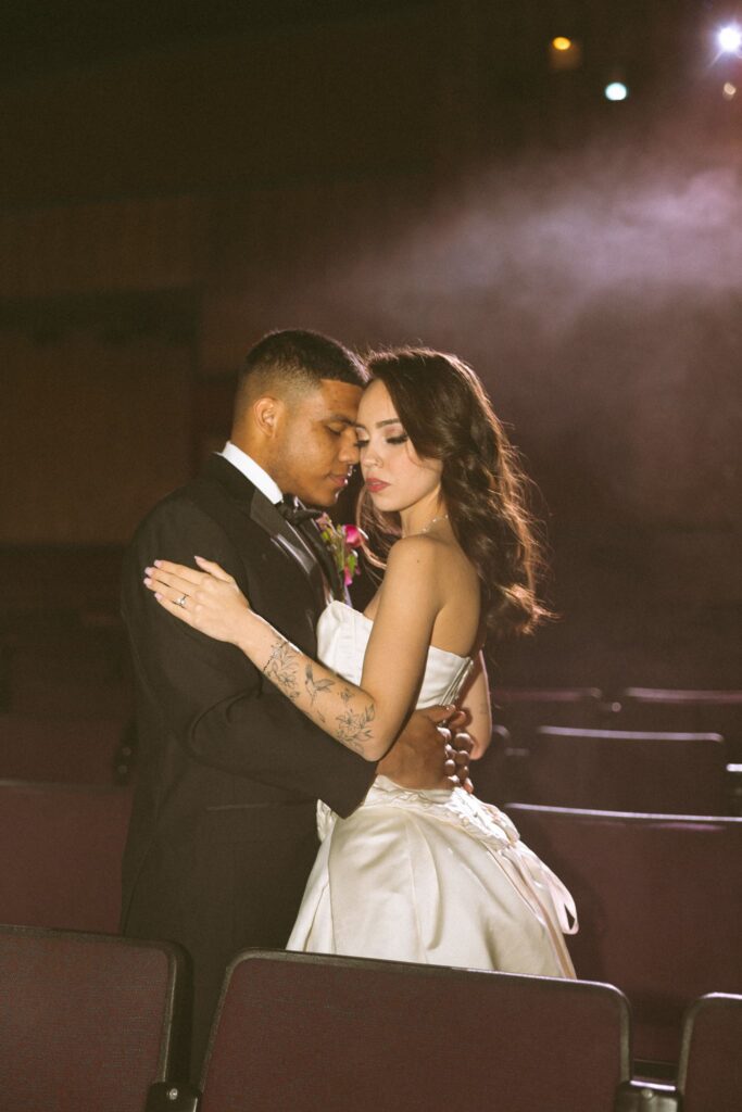 portrait of the groom kissing the bride on the cheek