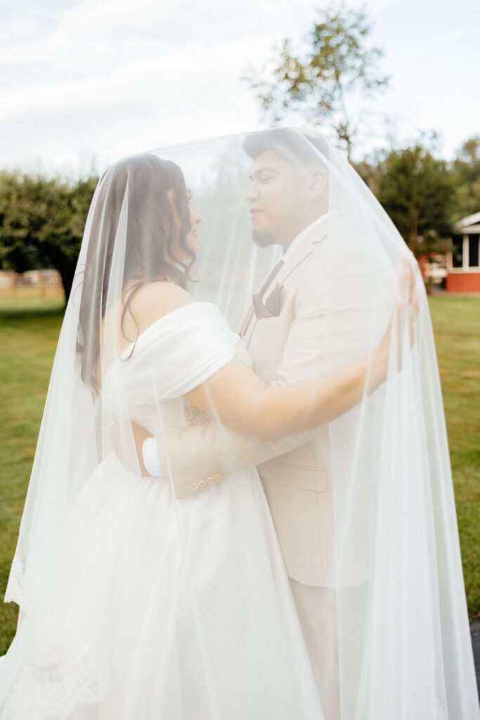bride and groom smiling at each other during their photoshoot