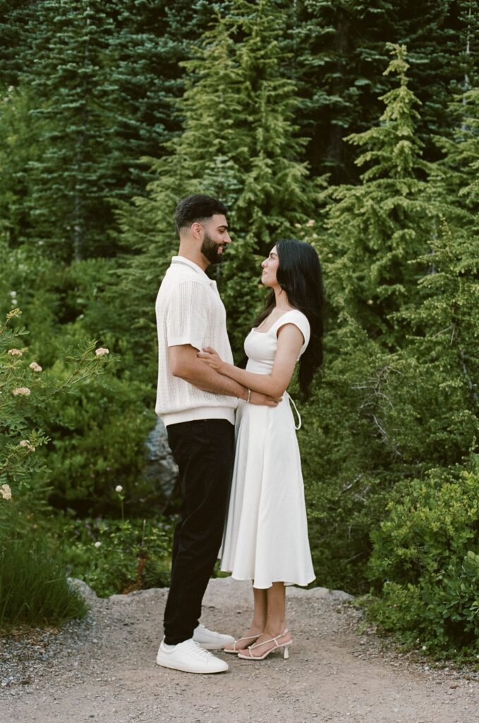 newly engaged couple smiling at each other during their photoshoot
