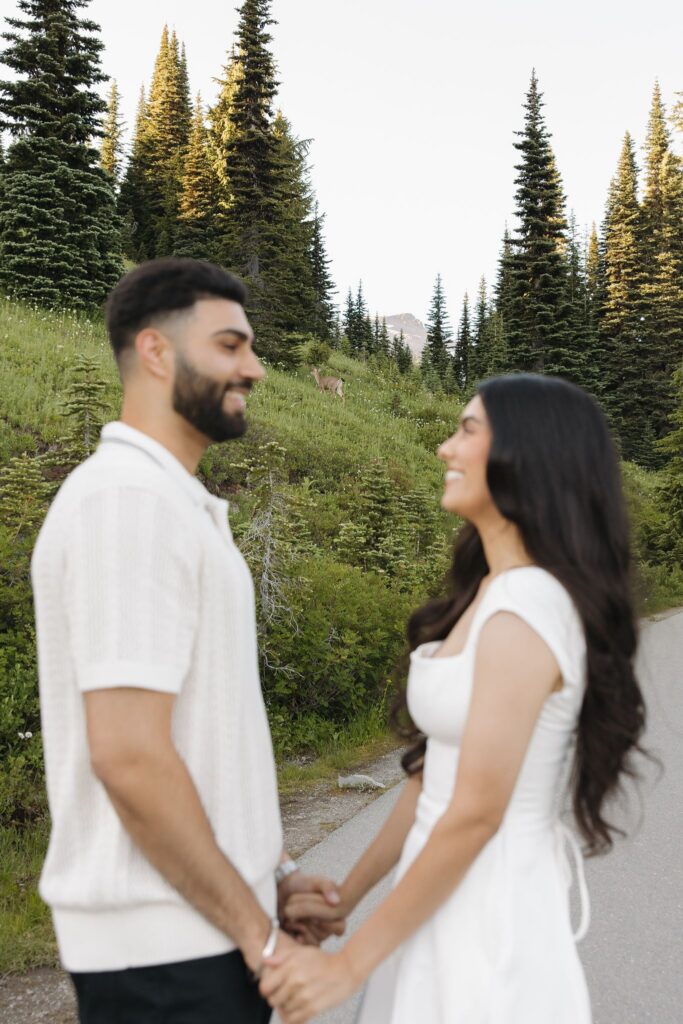 newly engaged couple smiling at each other